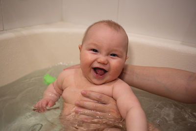 Portrait of cute baby boy in bathroom