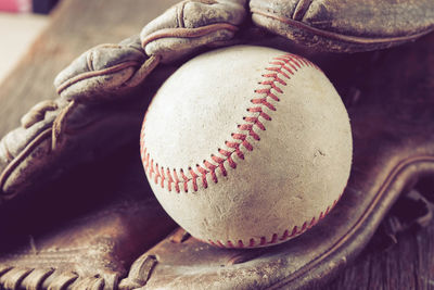 Close-up of baseball equipment on table