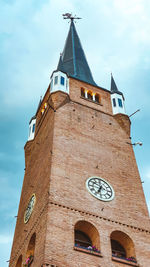 Low angle view of clock tower against sky