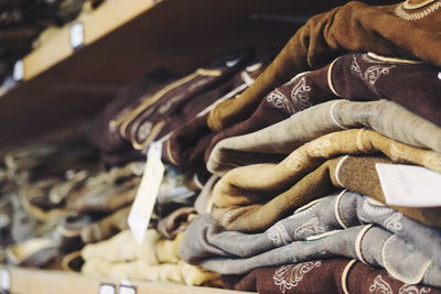 Close-up of stacked clothing on shelves in store