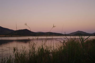 Scenic view of lake against sky during sunset