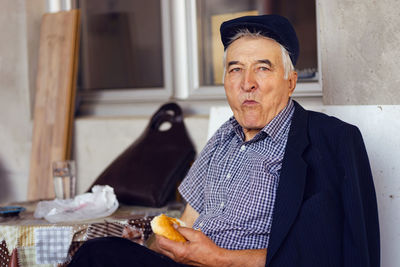 Portrait of man sitting at home