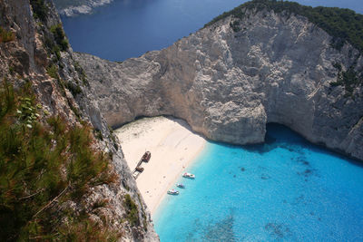 Scenic view of cliff by sea against sky