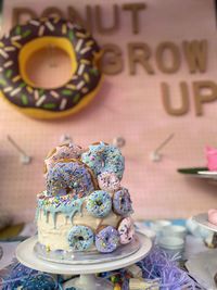 Close-up of a cake with doughnuts on table