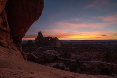 Full frame view of sunset with sandstone rock formations in the foreground