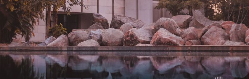 Panoramic view of lake and rocks against trees