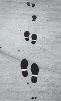 High angle view of footprints on sand