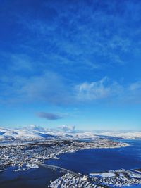 Aerial view of cityscape bay against sky in tromsø, norway