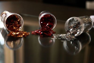 Close-up of wine glass glittering stars on table