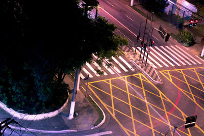 High angle view of road by illuminated street at night