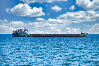 Ship sailing in sea against sky