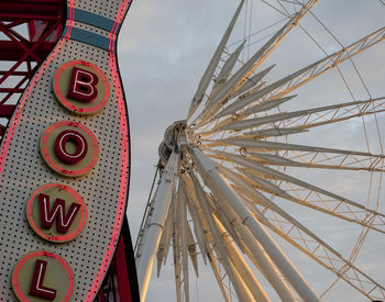 Low angle view of ferris wheel against sky