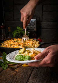 Midsection of person holding food on table