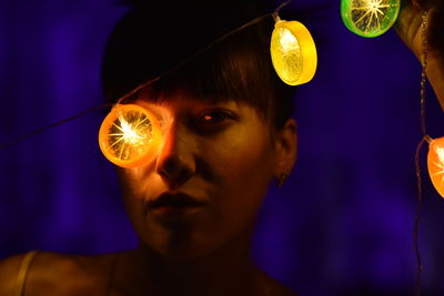 Portrait of woman with illuminated lighting equipment