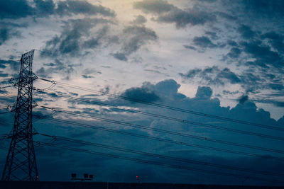 Low angle view of electricity pylon against sky