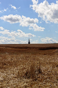 Man standing on field against sky