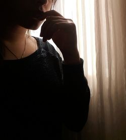 Close-up of young woman looking away at home