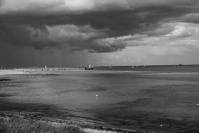 Scenic view of sea against cloudy sky