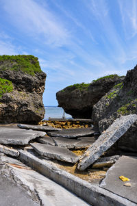 Rocks on beach against sky