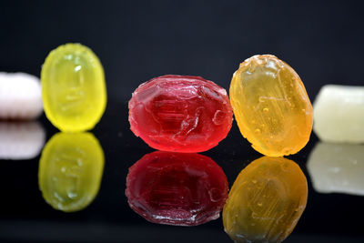 Close-up of multi colored candies against black background