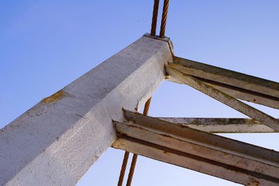 Low angle view of traditional windmill against blue sky