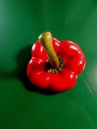 Close-up of red chili peppers on green table