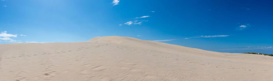 Scenic view of desert against blue sky