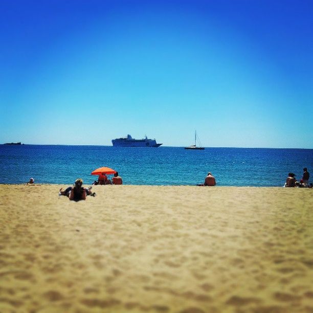 sea, beach, water, horizon over water, clear sky, blue, sand, copy space, shore, vacations, leisure activity, large group of people, scenics, tranquil scene, tranquility, lifestyles, beauty in nature, person, nature