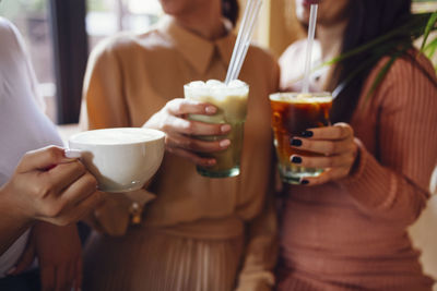 Midsection of woman holding drink