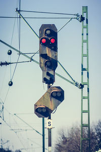 Road signal against sky on sunny day