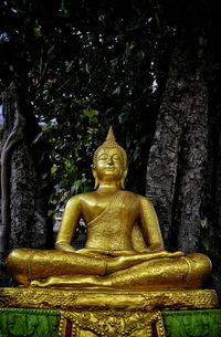 Low angle view of statue against trees