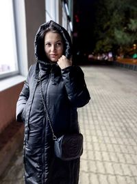 Portrait of beautiful young woman standing outdoors