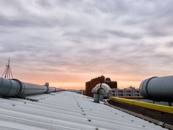 Roof against cloudy sky during sunset