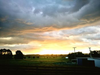 Scenic view of field against sky during sunset
