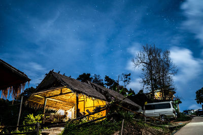 Low angle view of house on field against sky at night