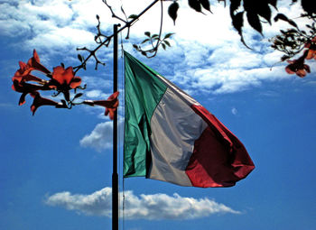 Low angle view of flag against blue sky