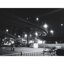 Illuminated bridge against clear sky at night