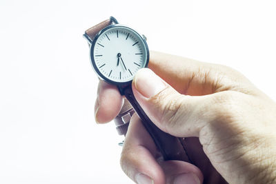 Person holding clock against white background