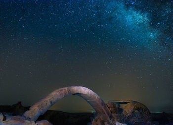 Scenic view of rock against sky at night