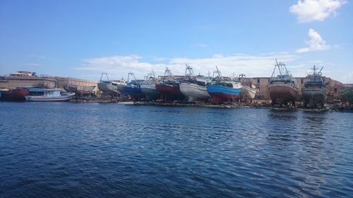 Boats in sea against blue sky