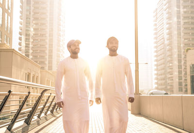 Men standing against skyscrapers in city