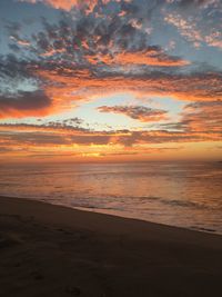 Scenic view of beach against sky during sunset