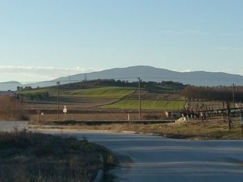 Scenic view of field against clear blue sky