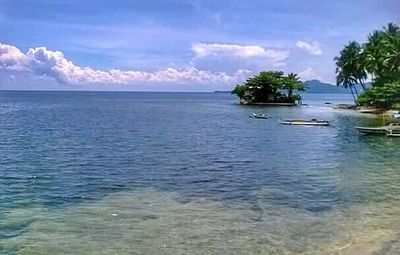 Scenic view of sea against cloudy sky