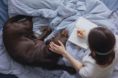 High angle view of woman sleeping on bed