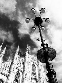 Low angle view of building against cloudy sky