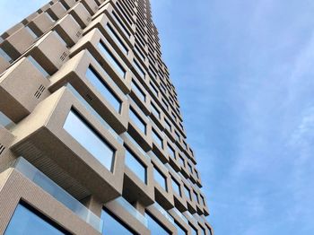 Low angle view of modern building against blue sky