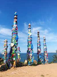 Multi colored umbrellas at beach against sky