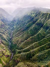 High angle view of green landscape against sky