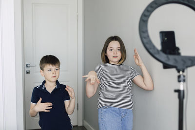 Boy and girl making dance tutorial at home